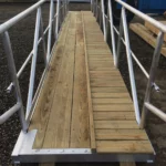 Truss style ramp, wooden decking split for walkway and trap slide.